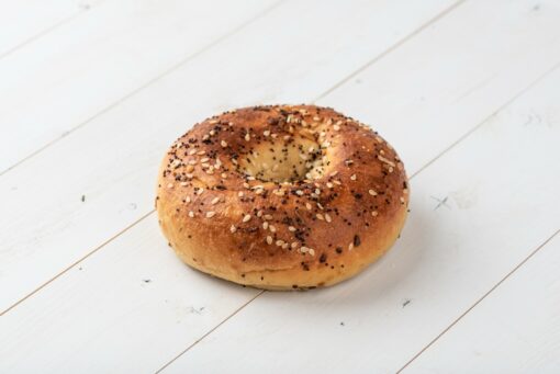 Perfect 10 Maxx Everything Protein Bagel on a wooden board