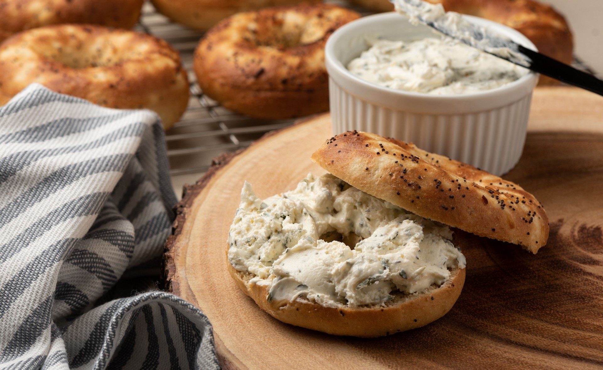 Bagels on wood board with cream cheese