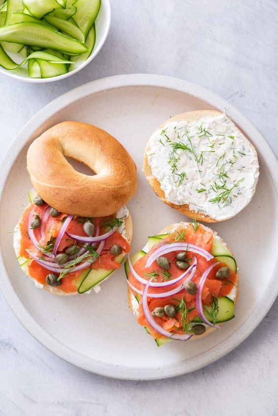 Two Traditional Lox Bagel Sandwiches, Open Faced. Smoked Lox, Cured Lox, Capers, Thin Slice Red Onion, Cucumber, Yummy Dill. Bagels and Lox