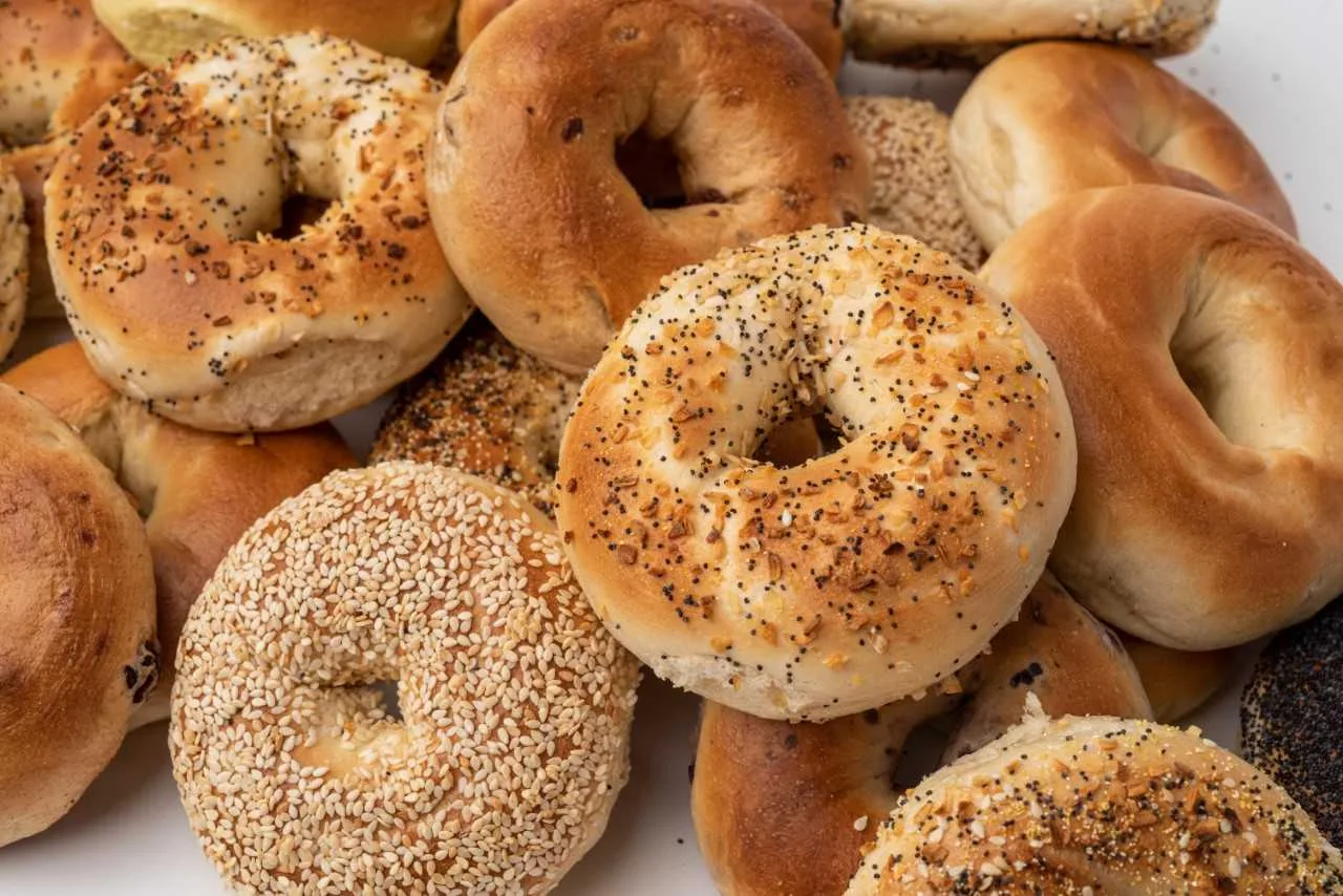 Bagel hole. Why do Bagels have Holes? Sesame bagel, Onion Bagel, bagel variety in a pile. Western Bagels in a pile.