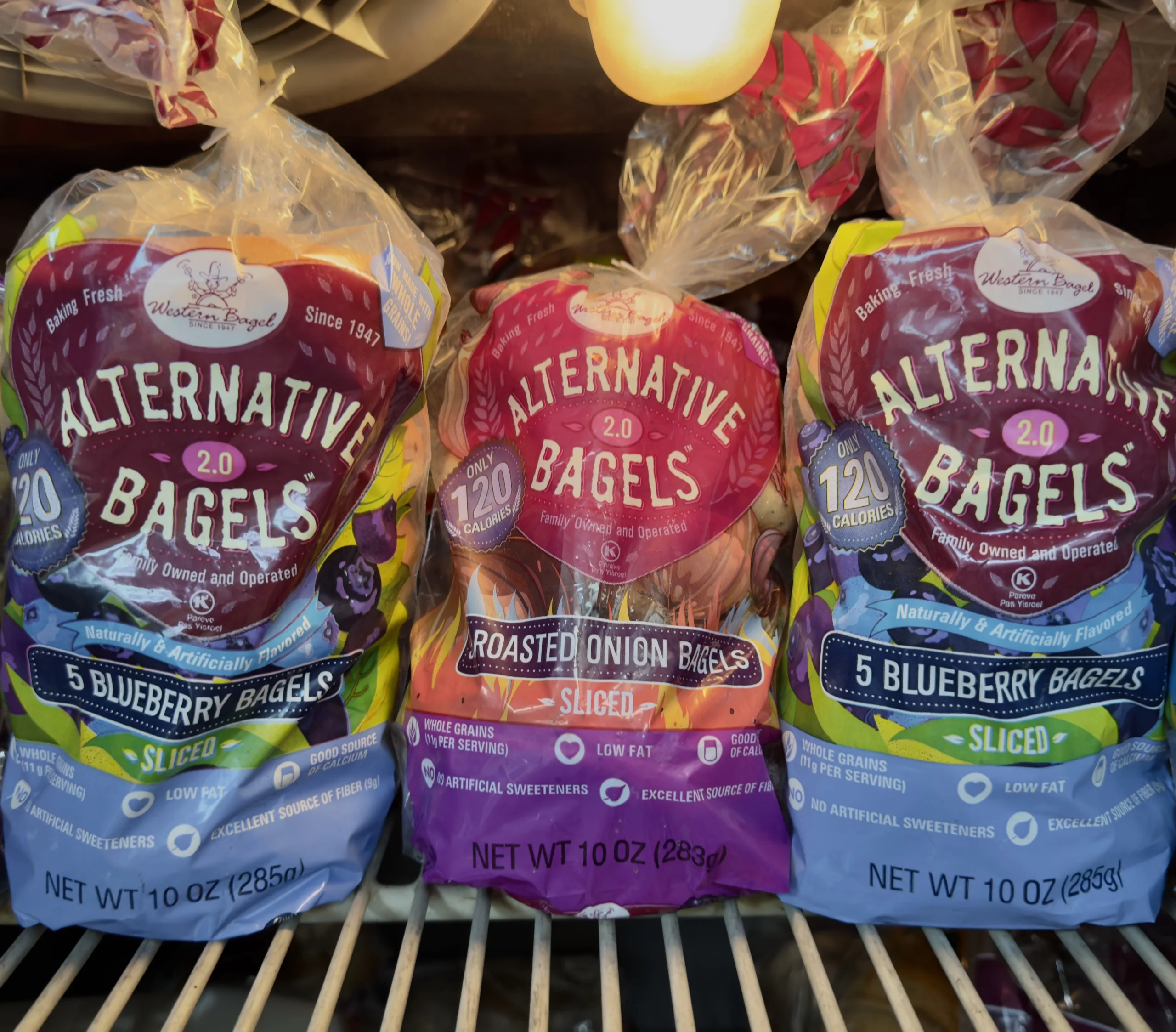 Alternative Bagels in the Freezer. Three bags of low-carb bagels in the freezer.